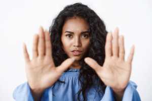 victim-abuse-danger-women-concept-closeup-alarmed-seriouslooking-african-american-curlyhaired-woman-stretch-hands-forward-stop-motion-say-no-enough-rejecting-something_176420-50627